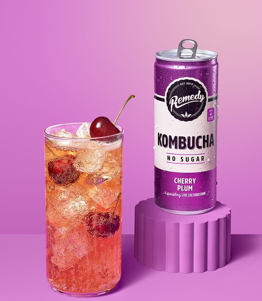 Remedy Kombucha Cherry Plum with glass